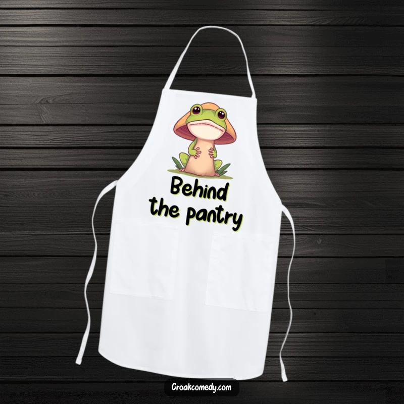 Funny frog apron featuring a curious frog peeking from behind a mushroom, perfect for adding a playful touch to kitchen duties.