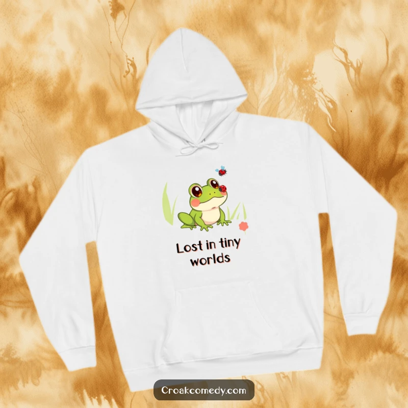 Funny hoodie featuring a frog with wide, innocent eyes looking up at a flying ladybug, designed for ultimate comfort and charm.