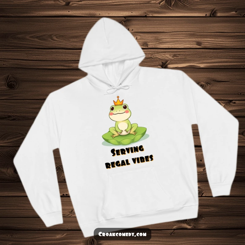 Funny Frog Hoodie: A regal frog with a crown, enjoying a lily pad ride, perfect for cozying up in kingly style, a funny gift.