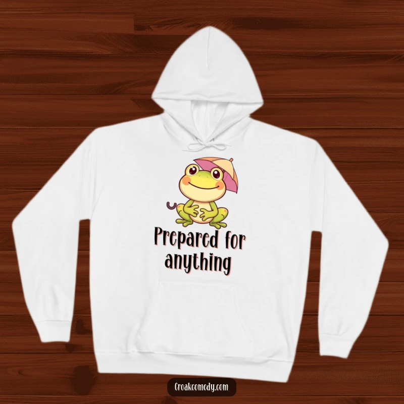 Funny, smiling frog holding a tiny umbrella on a cozy hoodie, bringing warmth and humor to any occasion, a lovely gift.