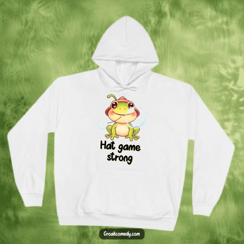 Funny frog hoodie, wearing a tiny hat, blowing large bubbles, embodying cozy fun and cheerful vibes.