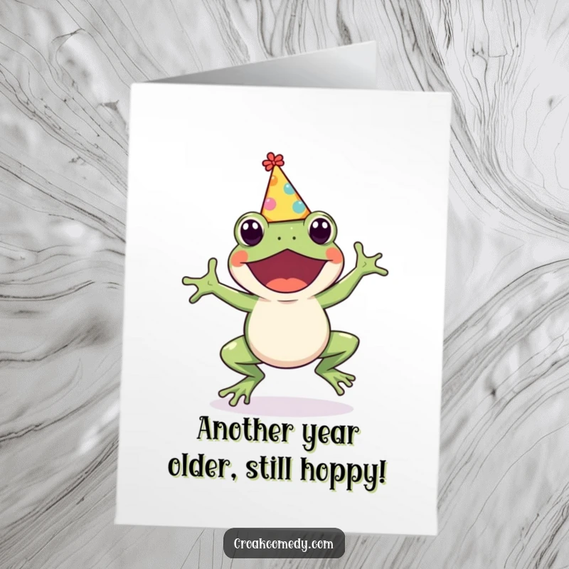 Funny Free Printable Birthday Card: A cute frog with a party hat joyfully hops, ready to celebrate with a downloadable gift.