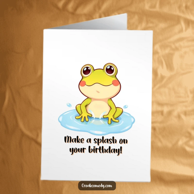 Funny Free Printable Birthday Card: A cartoon frog joyfully splashing and playing in a vibrant blue puddle, spreading cheer.
