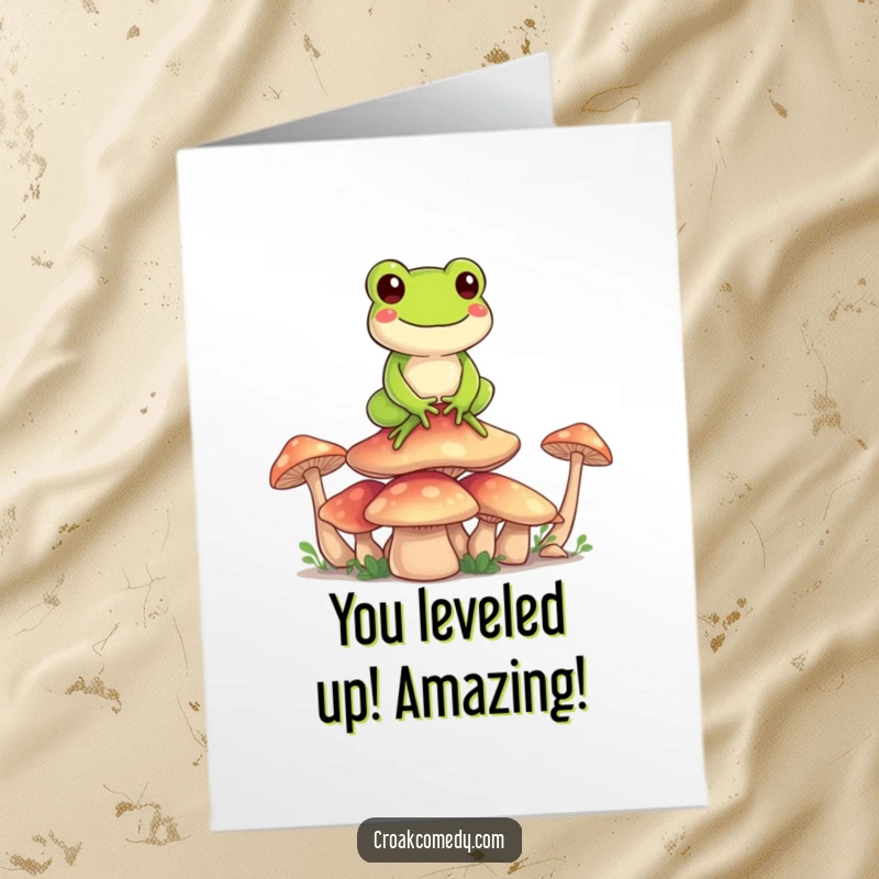 Funny Free Printable Congratulations Card: A happy frog balances perfectly on a stack of vibrant mushrooms, symbolizing reaching a new peak.