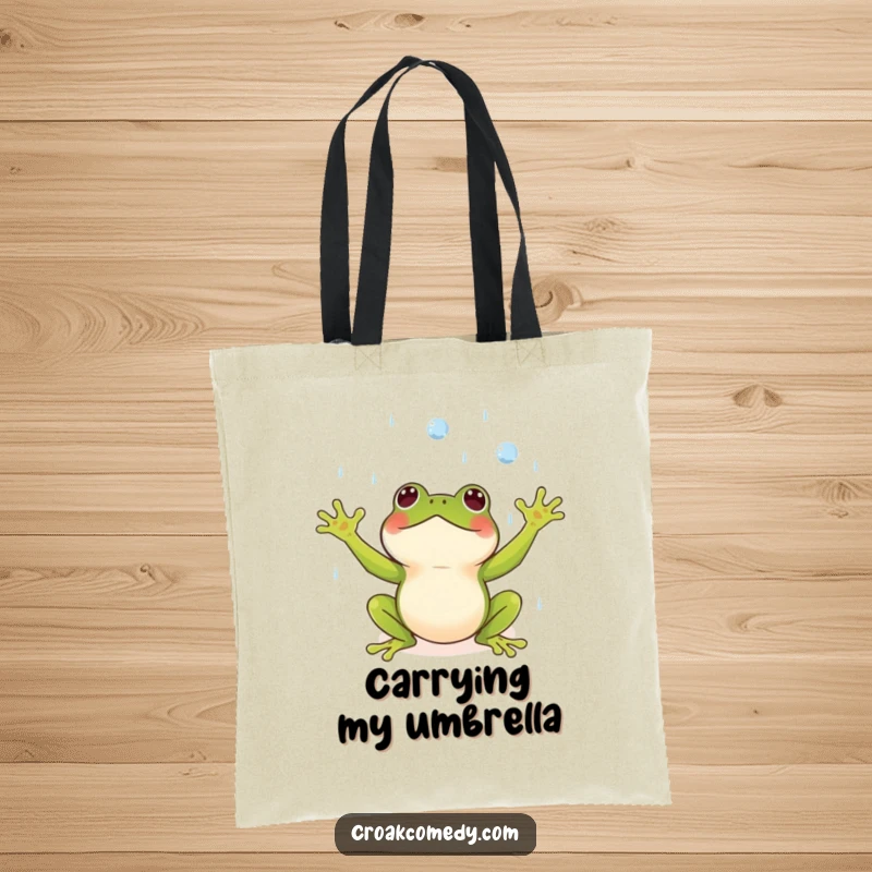 Funny tote bag featuring a small frog with arms outstretched, joyfully catching raindrops, perfect for carrying items.