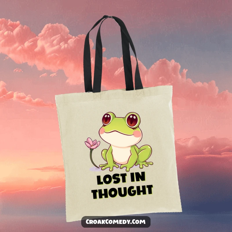 Funny Frog Tote Bag: A quirky frog with crossed eyes staring at a petal, a humorous and practical accessory.